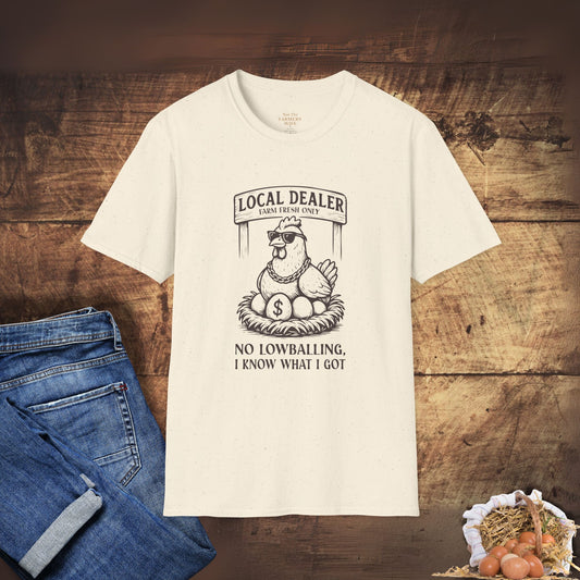 White t-shirt with graphic design on a wooden surface with jeans and eggs.