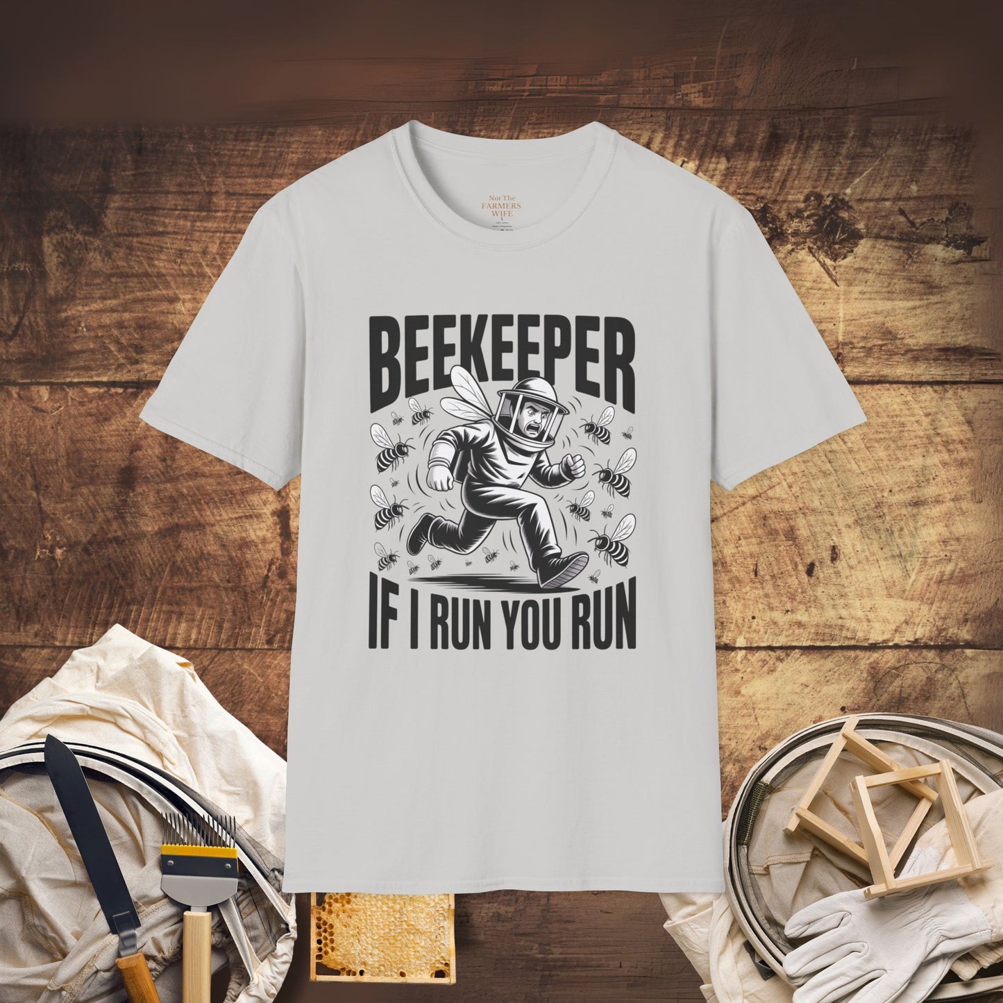 White t-shirt with beekeeper graphic and text on a wooden background